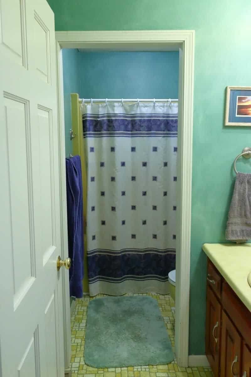 Bathroom remodeling - before. Green walls, yellow floor, counter and tub.