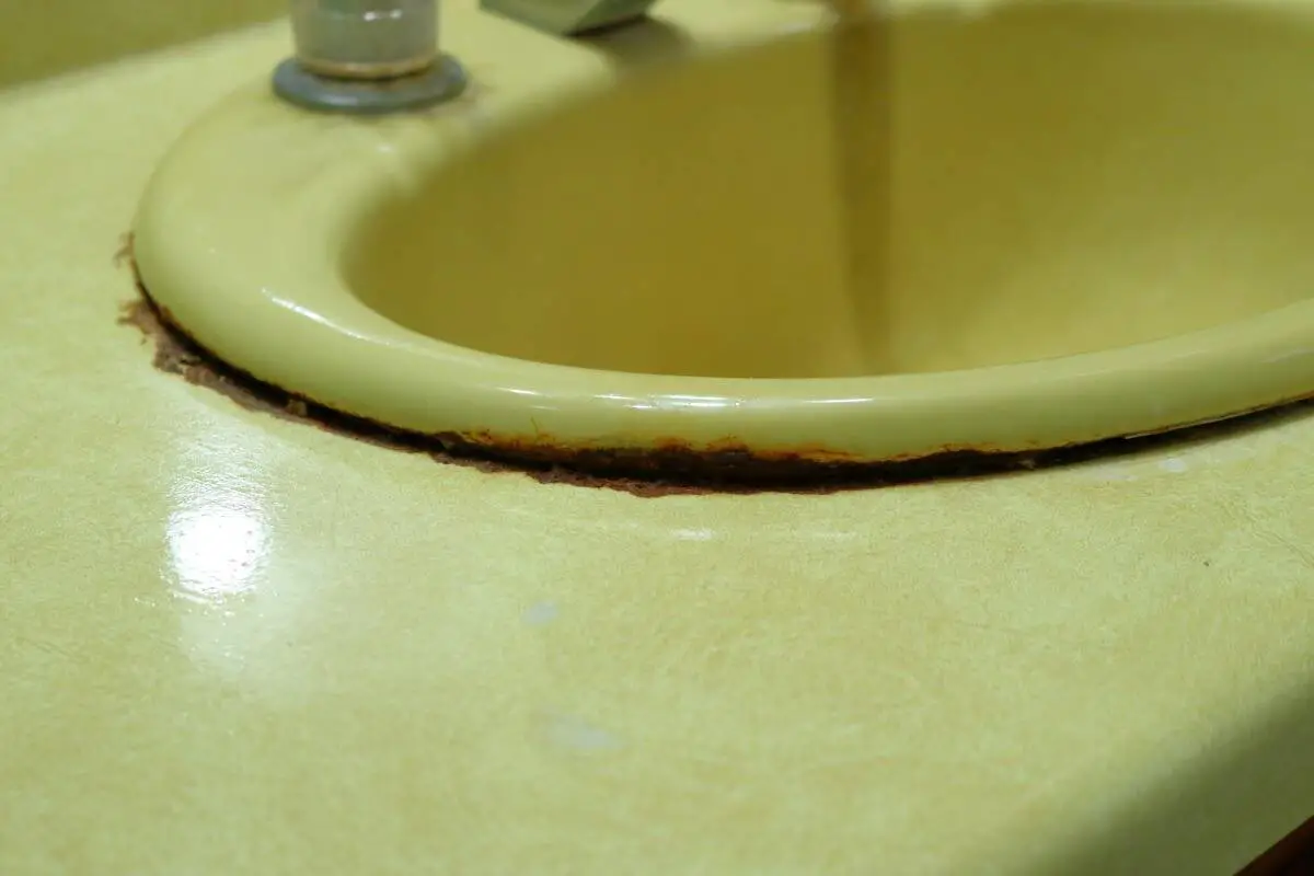 Harvest Gold bathroom sink and plastic laminate countertop