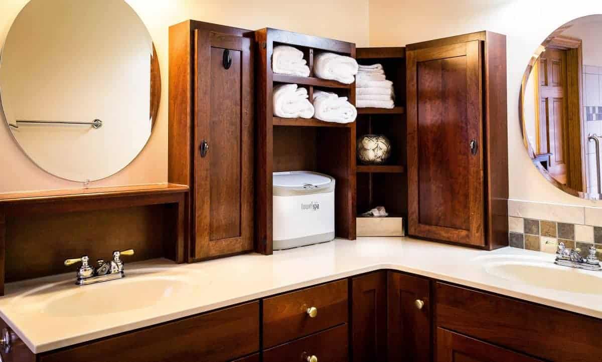 Bathroom vanity with storage tower on top of counter