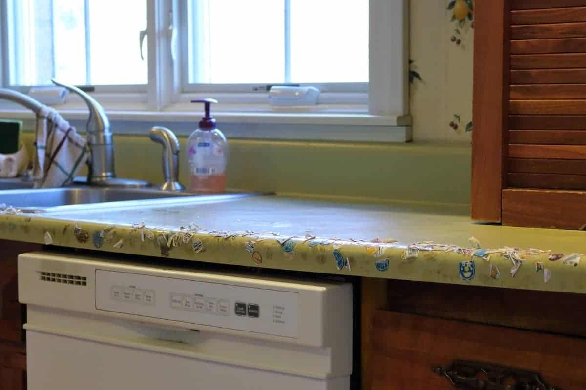 Kitchen makeover before - green counter, sink, white dishwasher