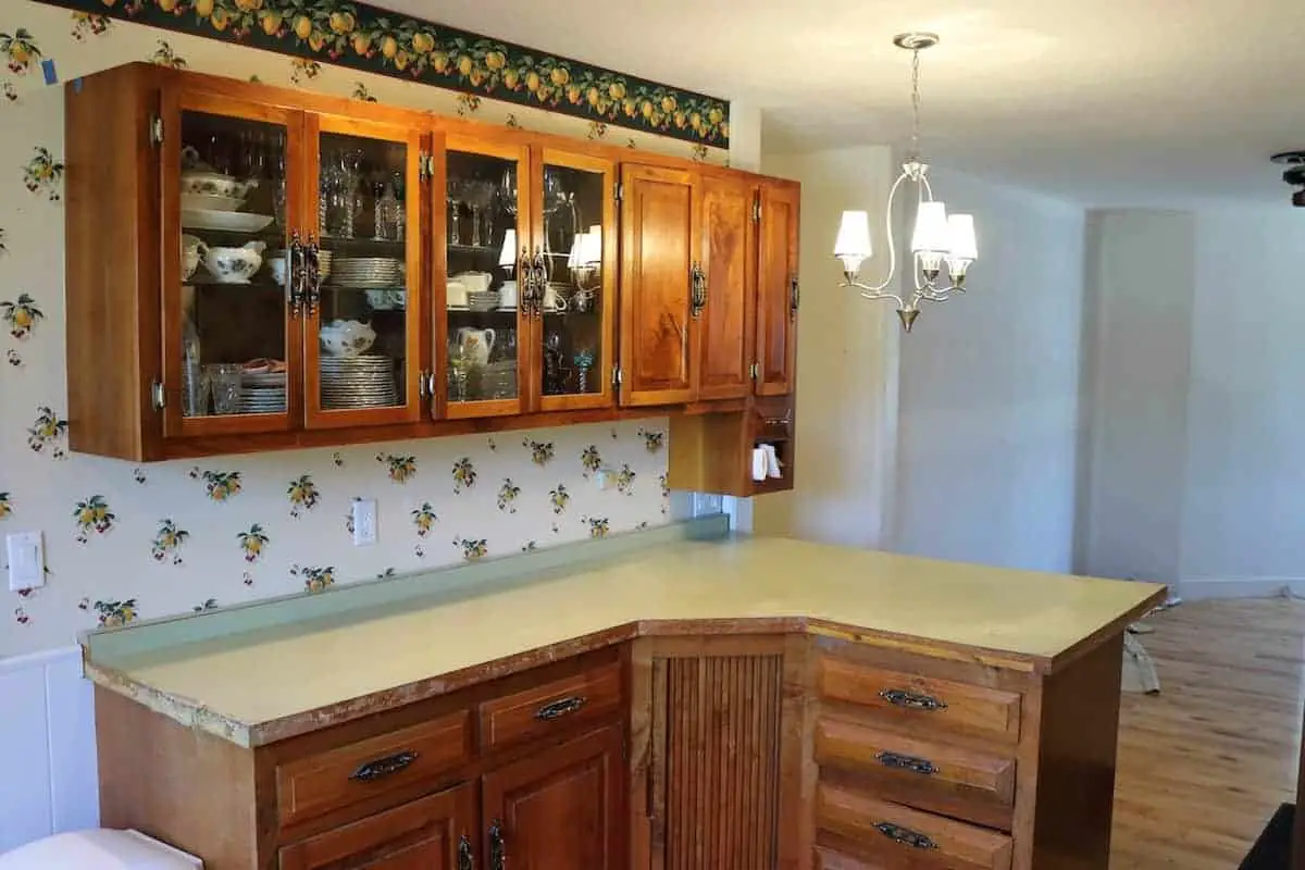 Kitchen remodel before with green formica counters and hickory cabinets