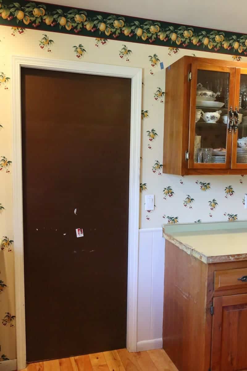 Dark brown door, green counters before the kitchen remodel