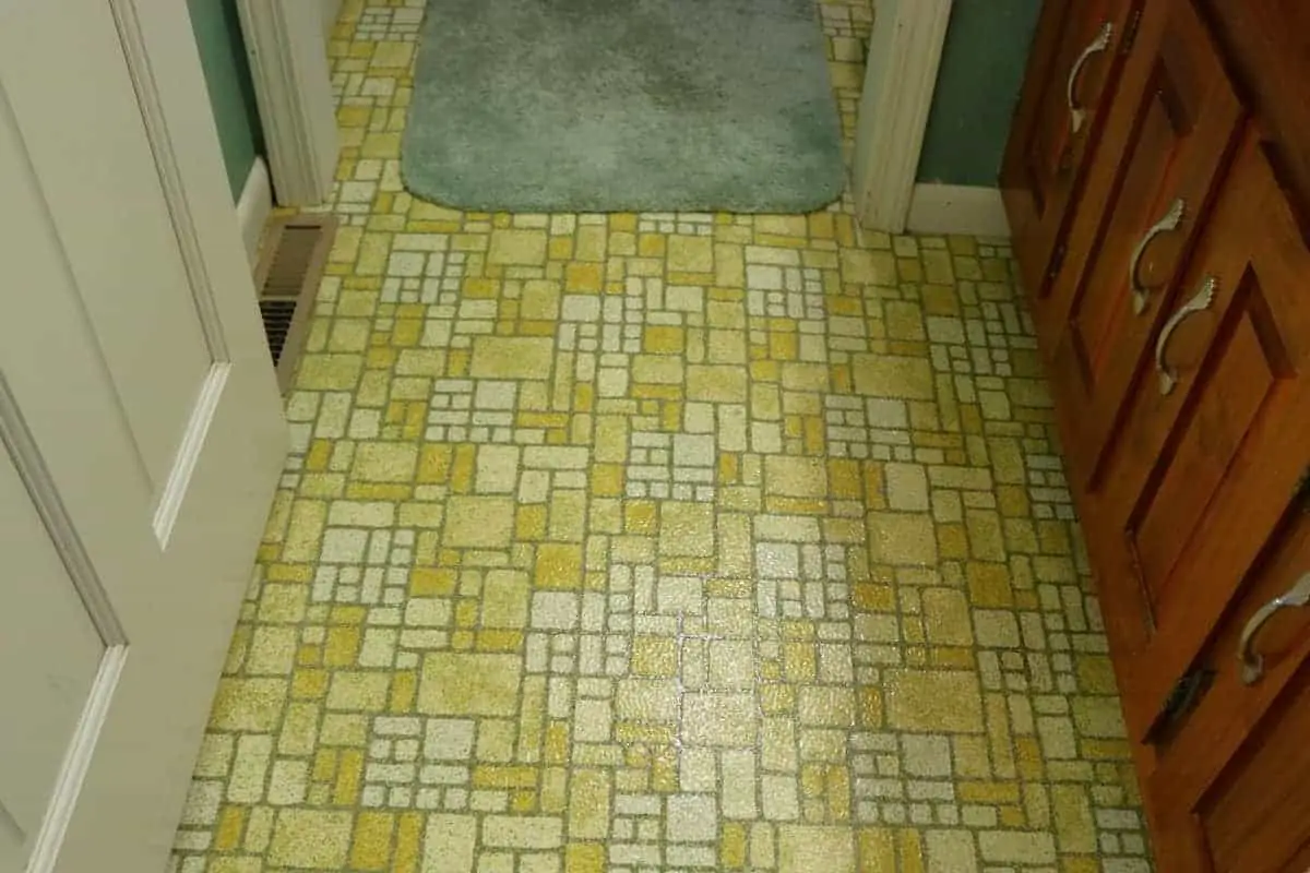Photo of original 1970's yellow linoleum floor prior to being covered with luxury vinyl tile 