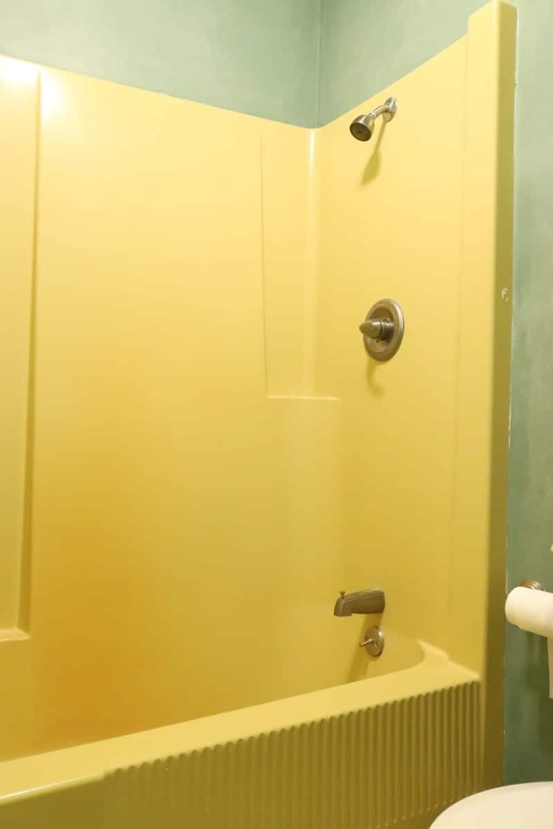 Harvest Gold fiberglass tub/shower unit from 1970s bathroom
