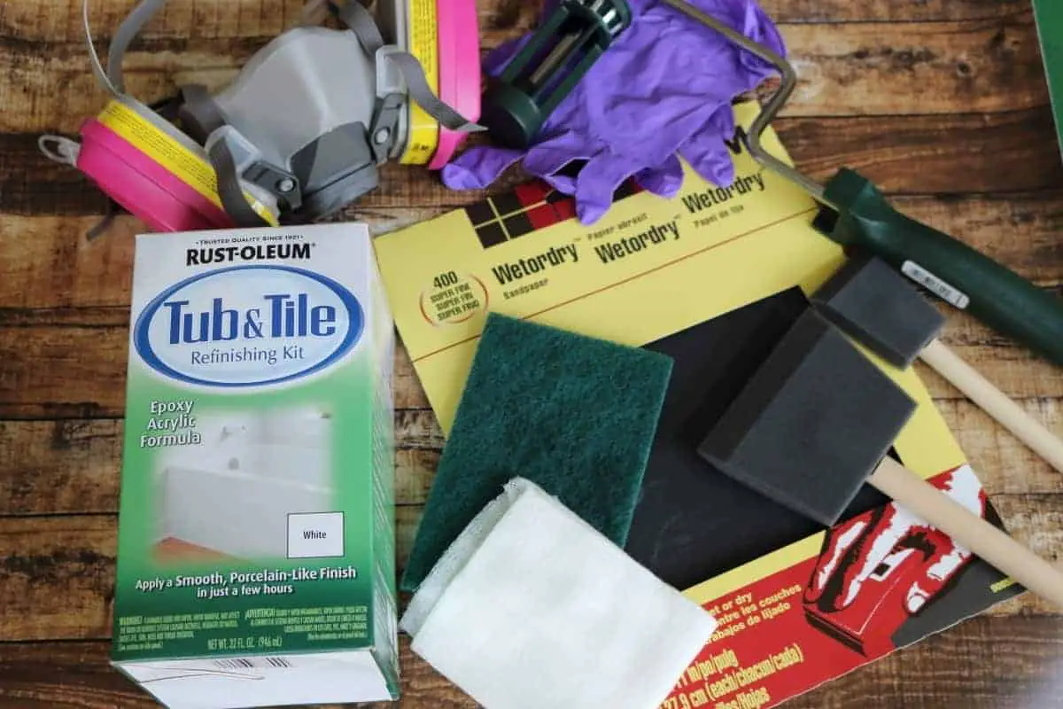 Photo of DIY Bathtub refinishing supplies - sandpaper, paintbrushes, gloves, respirator 