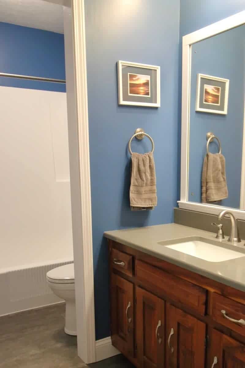 Bathroom remodel costs for a dark grey and blue bathroom with white trim.