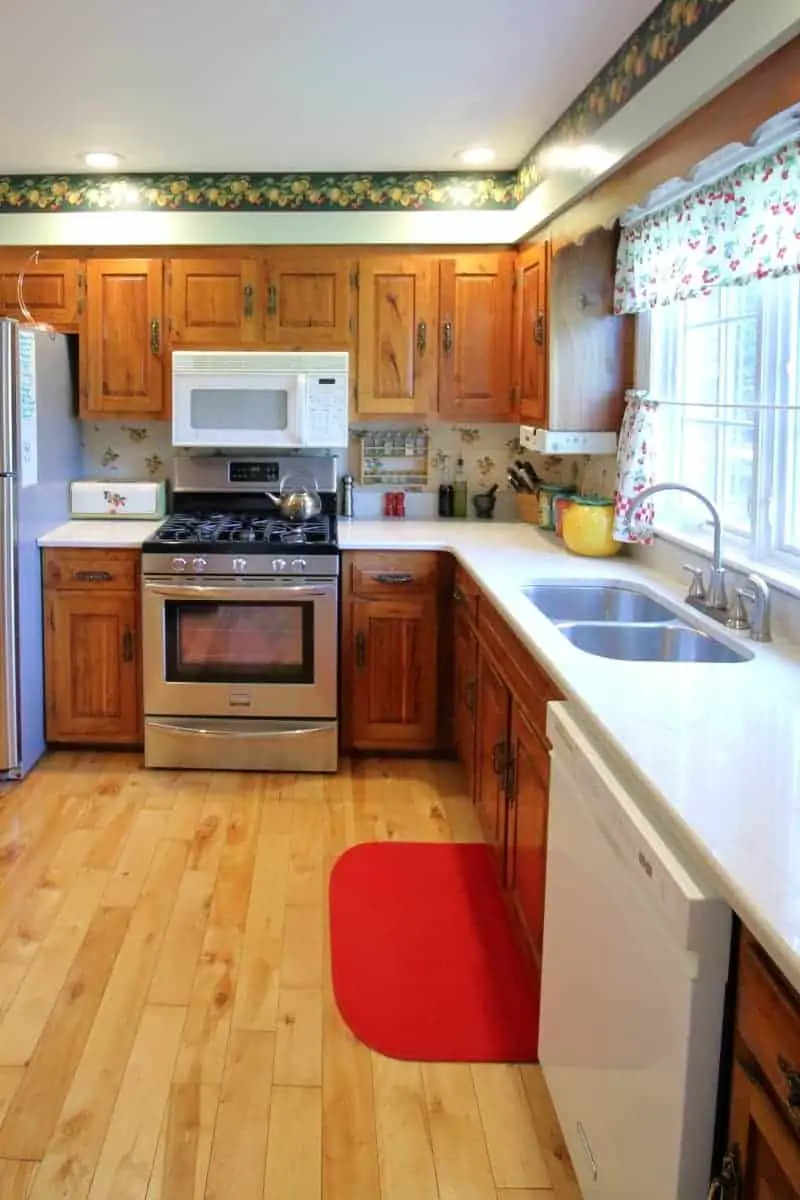 Kitchen remodel with white quartz countertops, hickory cabinets and maple floor