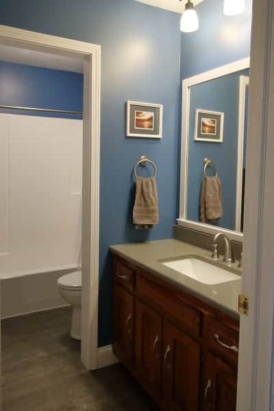 Bathroom remodel in dark grey and blue with white trim