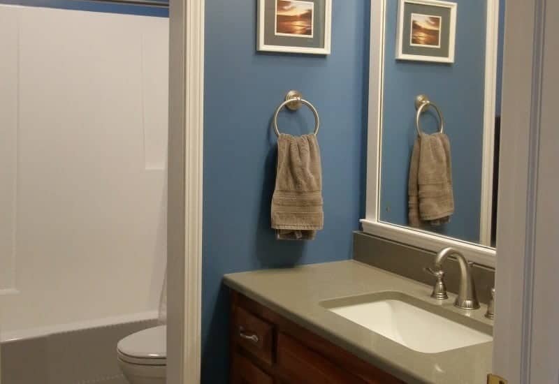 Bathroom remodel in dark grey and blue with white trim
