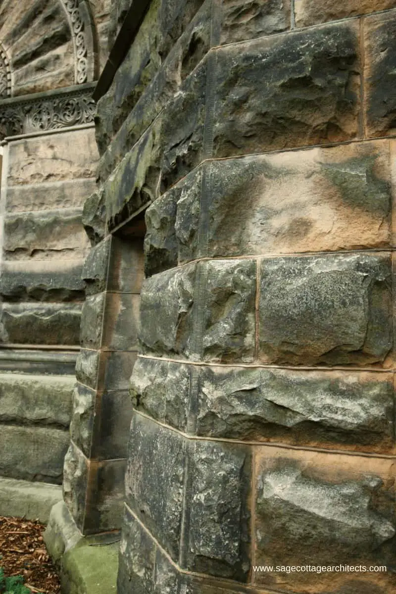 Close-up of rough faced ashlar masonry wall.