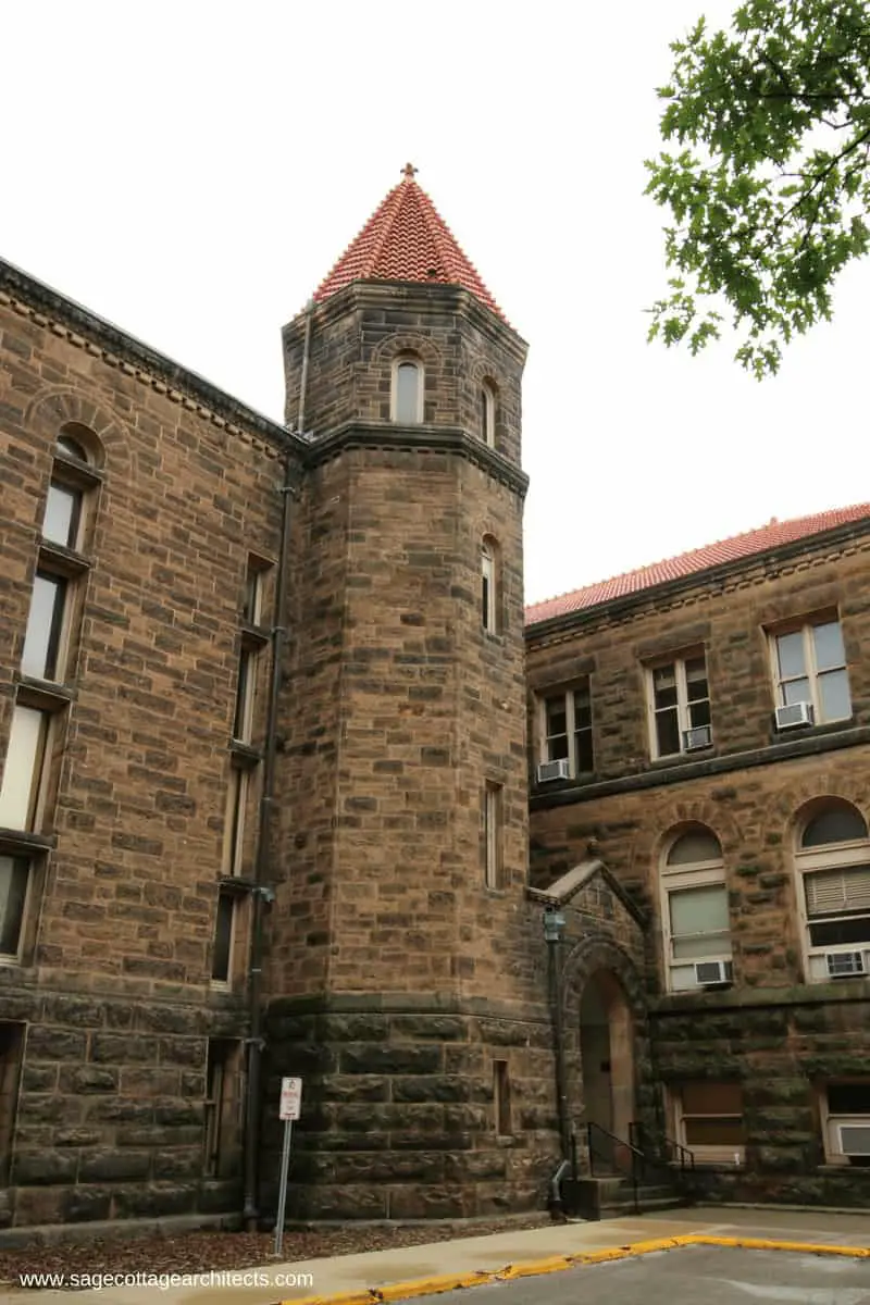 Polygonal turret with red tile hipped roof and ashlar limestone walls