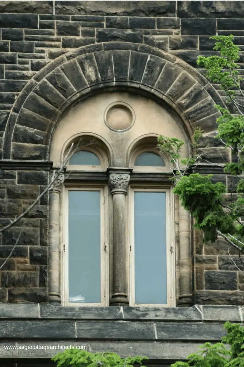 Richardsonian Romanesque building with paired windows, colonnettes and arched frame