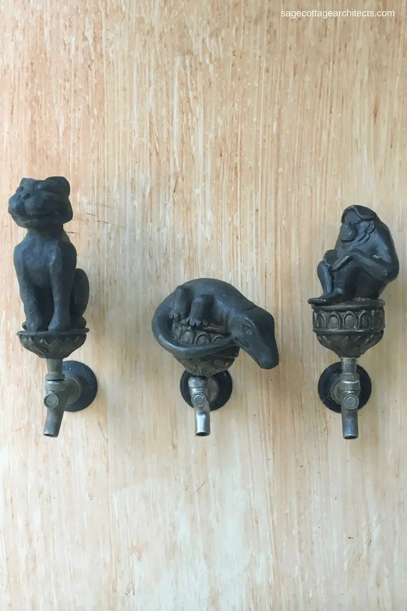 Three metal beer tap pulls in the shape of a tiger, a crocodile, and an ape at Walt Disney World Animal Kingdom