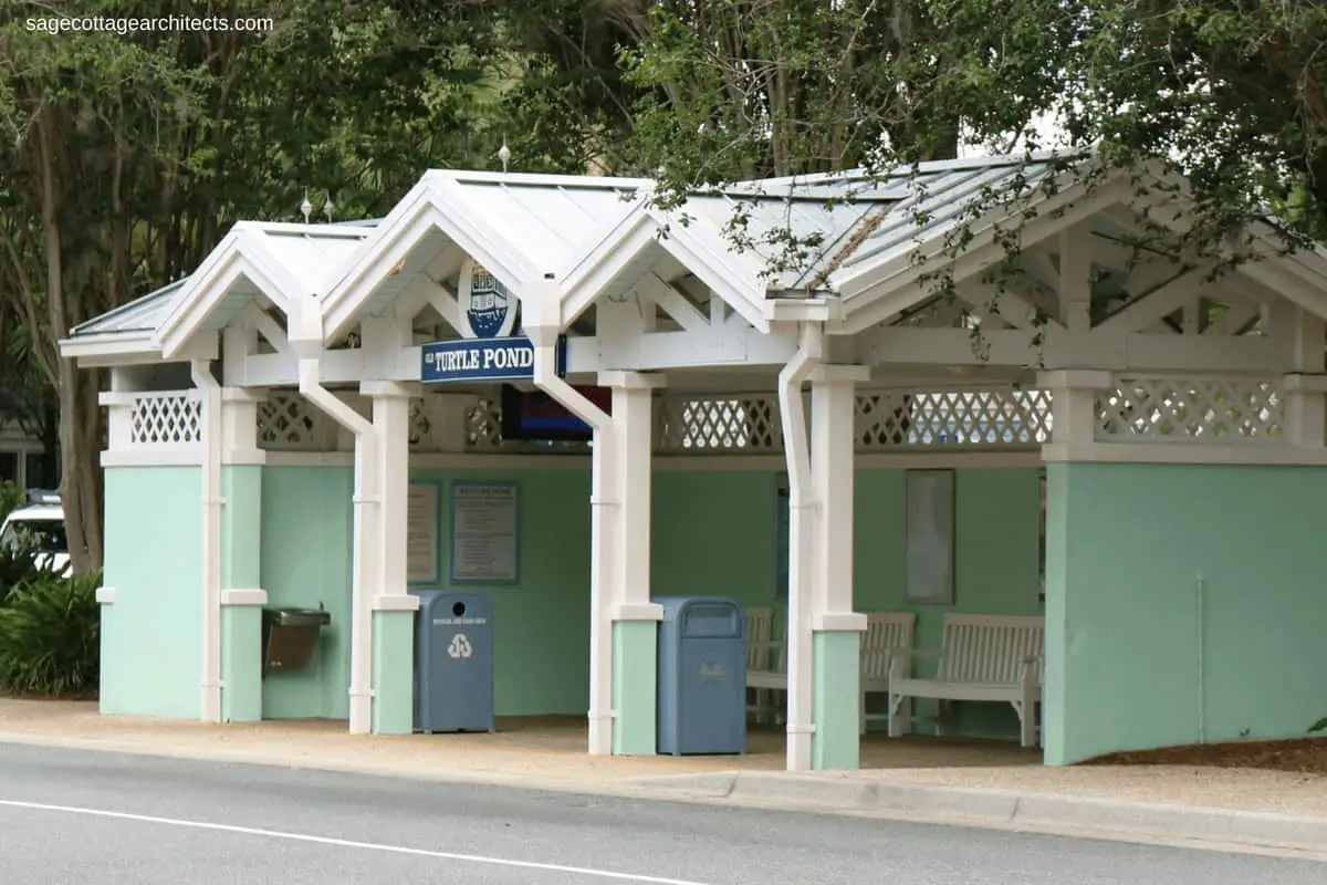 Small mint green covered bus stop with white gingerbread and grey metal roof at Disney's Old Key West Resort