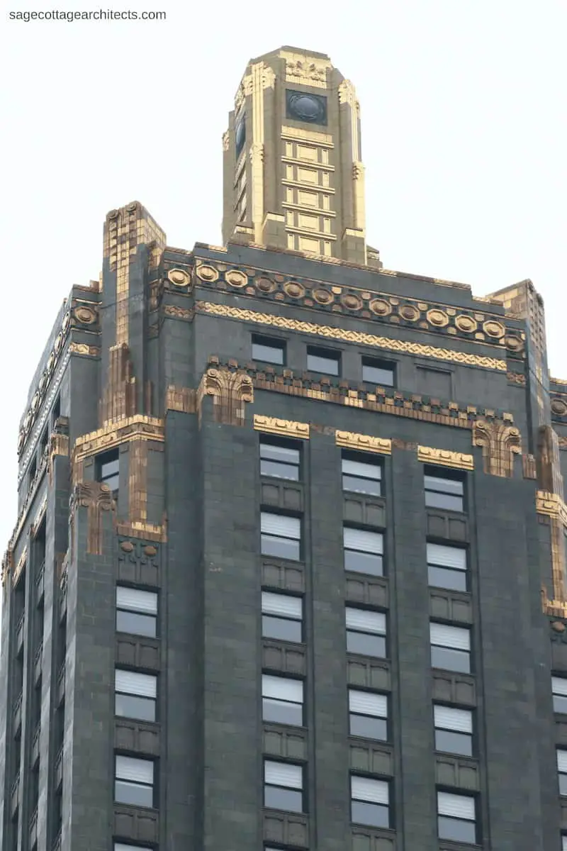 Top of the Carbide and Carbon Building dark green tower with bronze details and gold covered beacon.