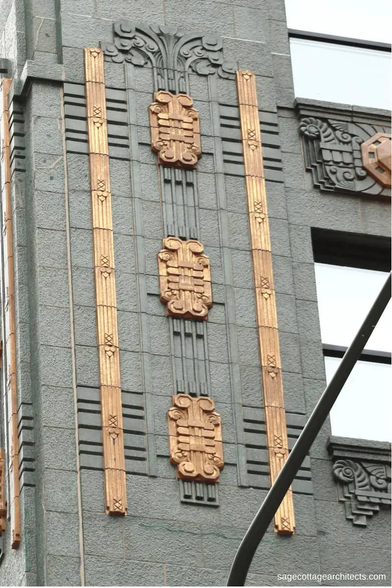 Green terra cotta walls of the Carbide and Carbon Building with bronze Art Deco details