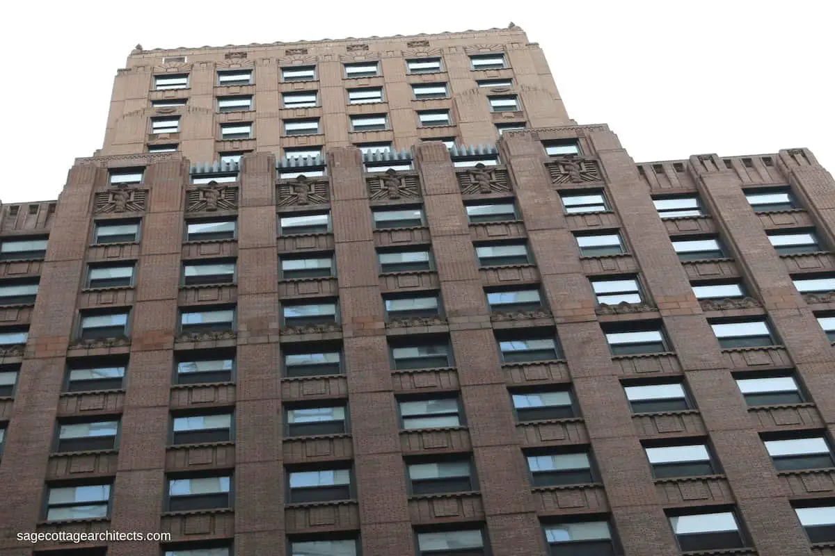 Building exterior with brown lower floors and tan upper floors.