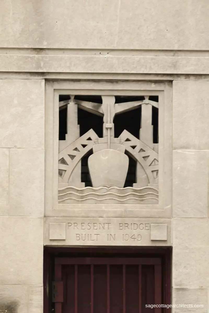 Art Deco styled carved limestone panel of a ship going under two lifted bridges