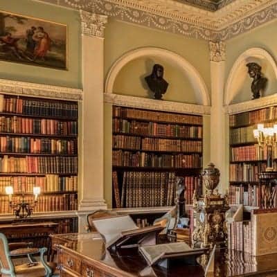 Ornate library with large built-in bookshelves.
