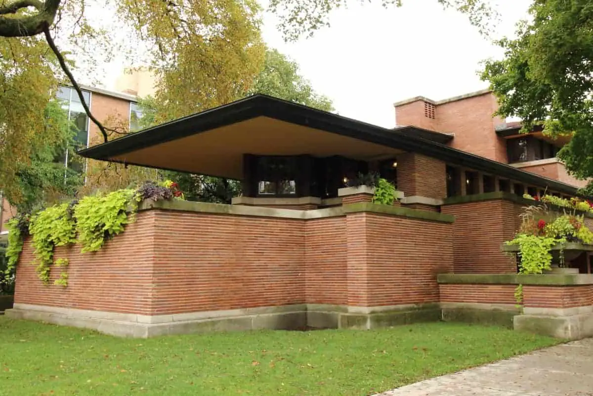 The red brick, white stone banding, and wide cantilevered roofs in this photo, are the prime characteristics of Prairie Style homes.