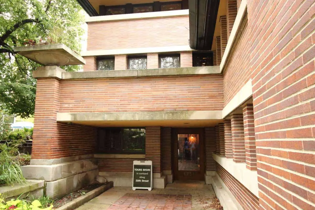 Entrances to Prairie Style homes are often hidden like this one, that is made of red brick and white limestone.