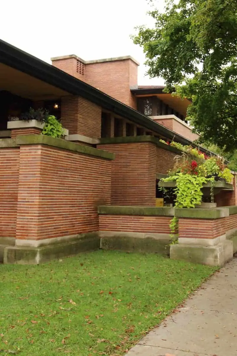 Photo of Prairie style home with red brick and white limestone banding