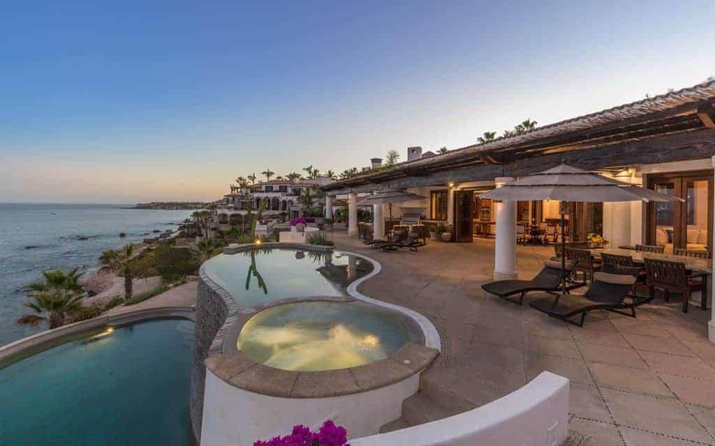 Photo of a beautiful beach vacation home with patio and two pools.