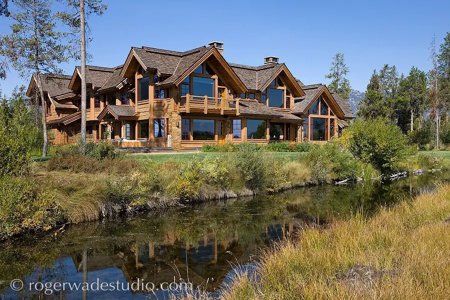 Picture of a large ski vacation home in the summertime. 