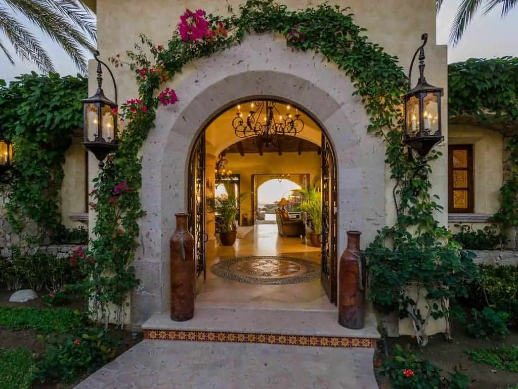 Photo of the entrance to a beach vacation home with limestone archway.