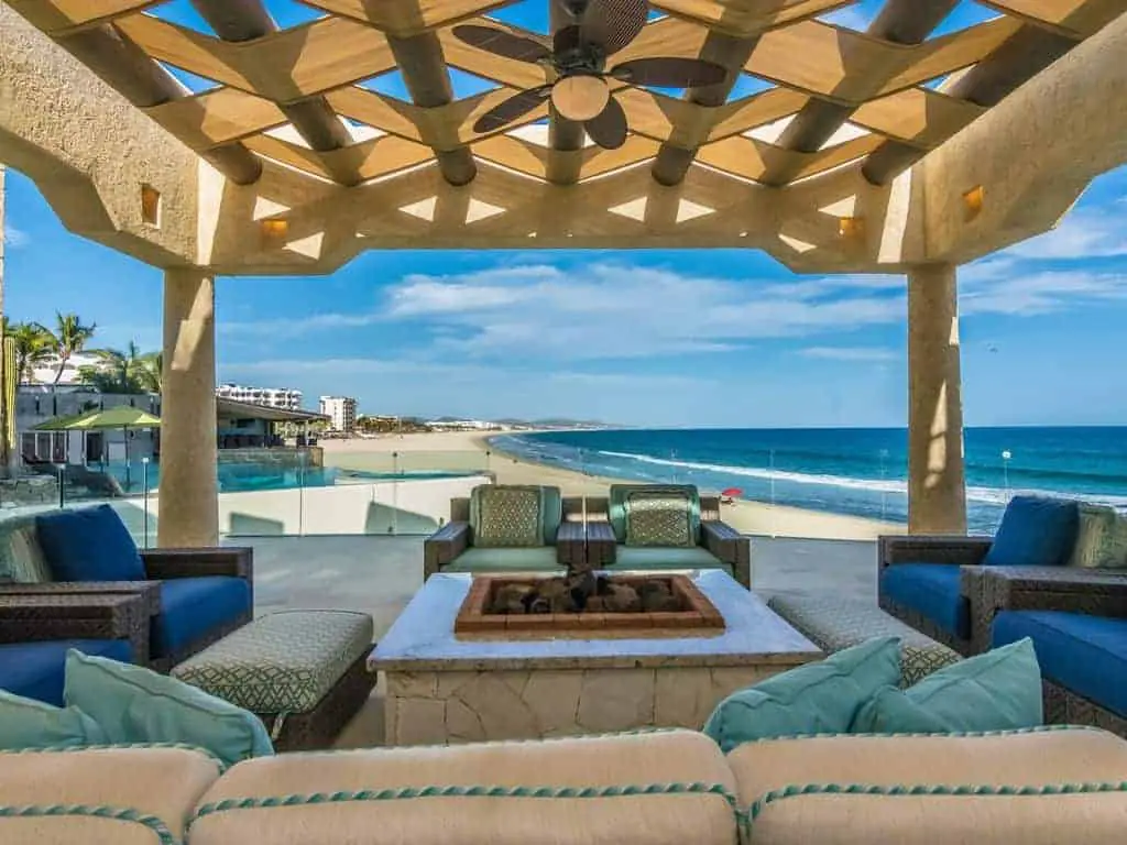 Photo of the perfect beach vacation home with a covered patio next to the ocean. 