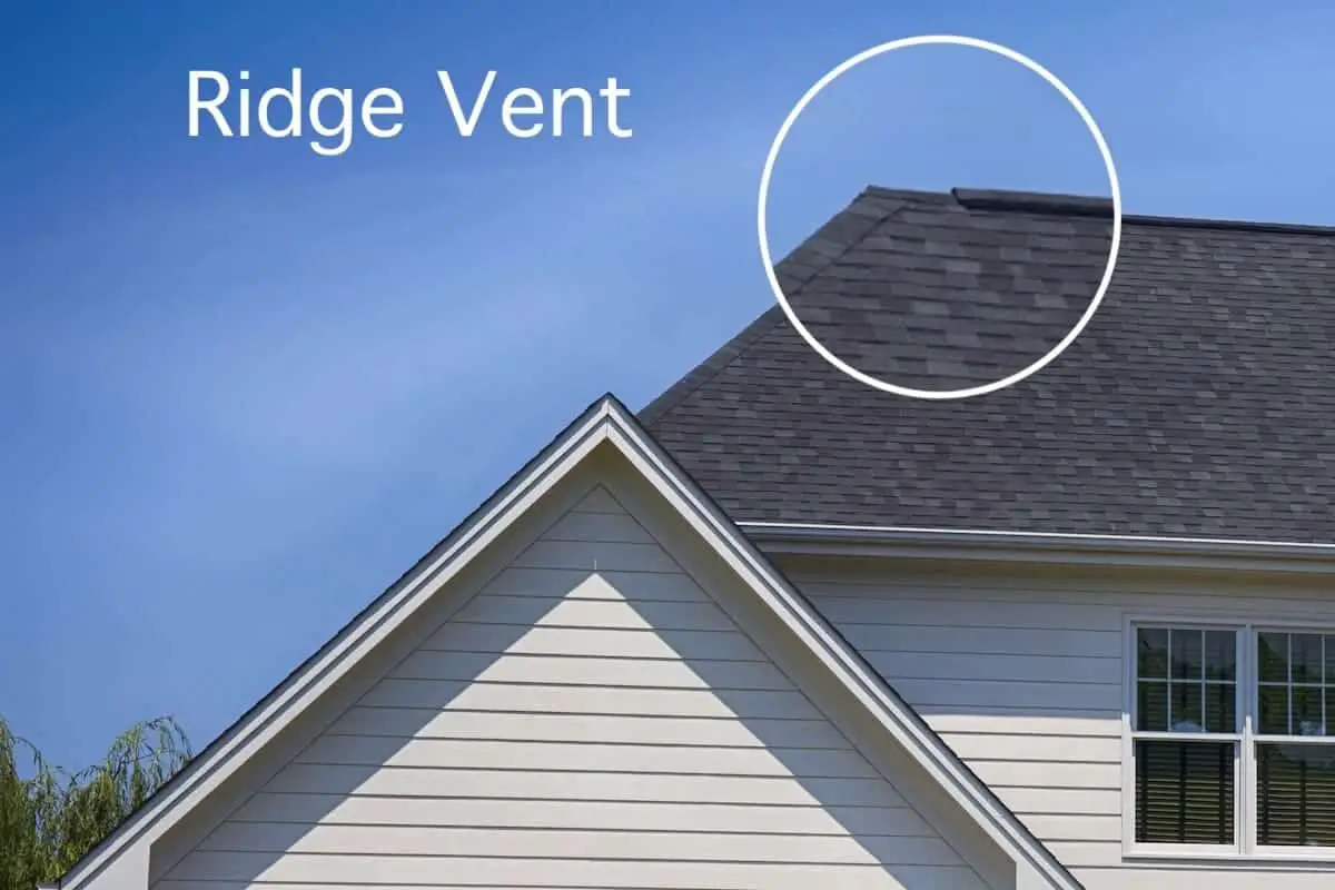 Photo of a white house with dark asphalt roof with a roof ridge vent.