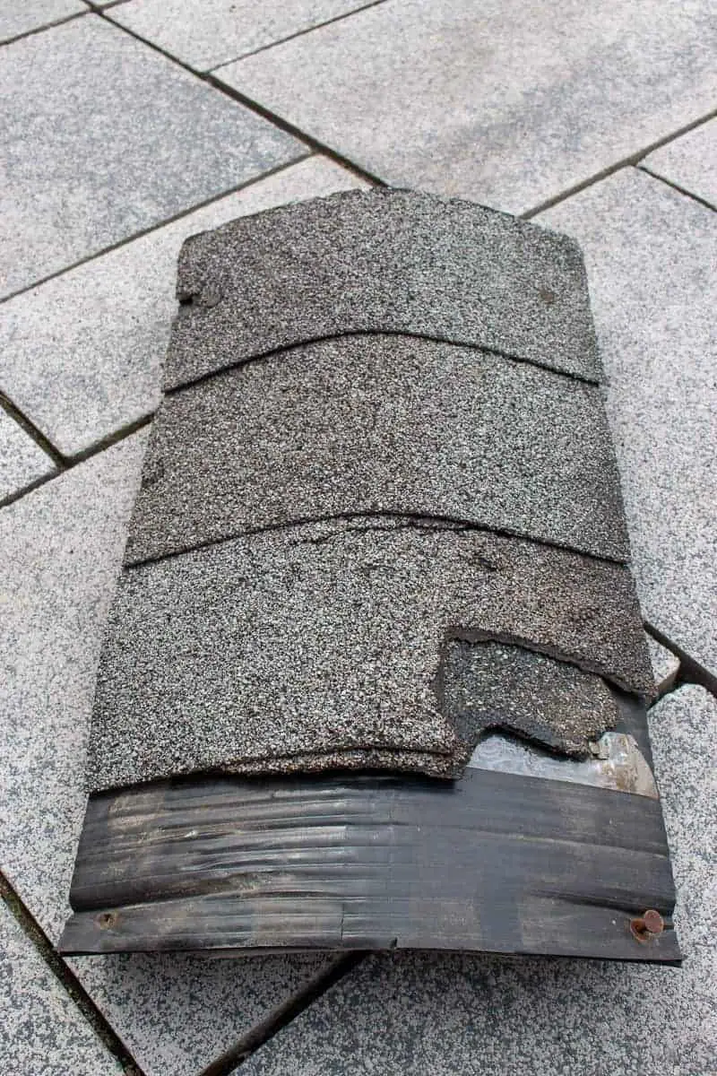 Photo of the old roof ridge vent with dark grey asphalt shingles