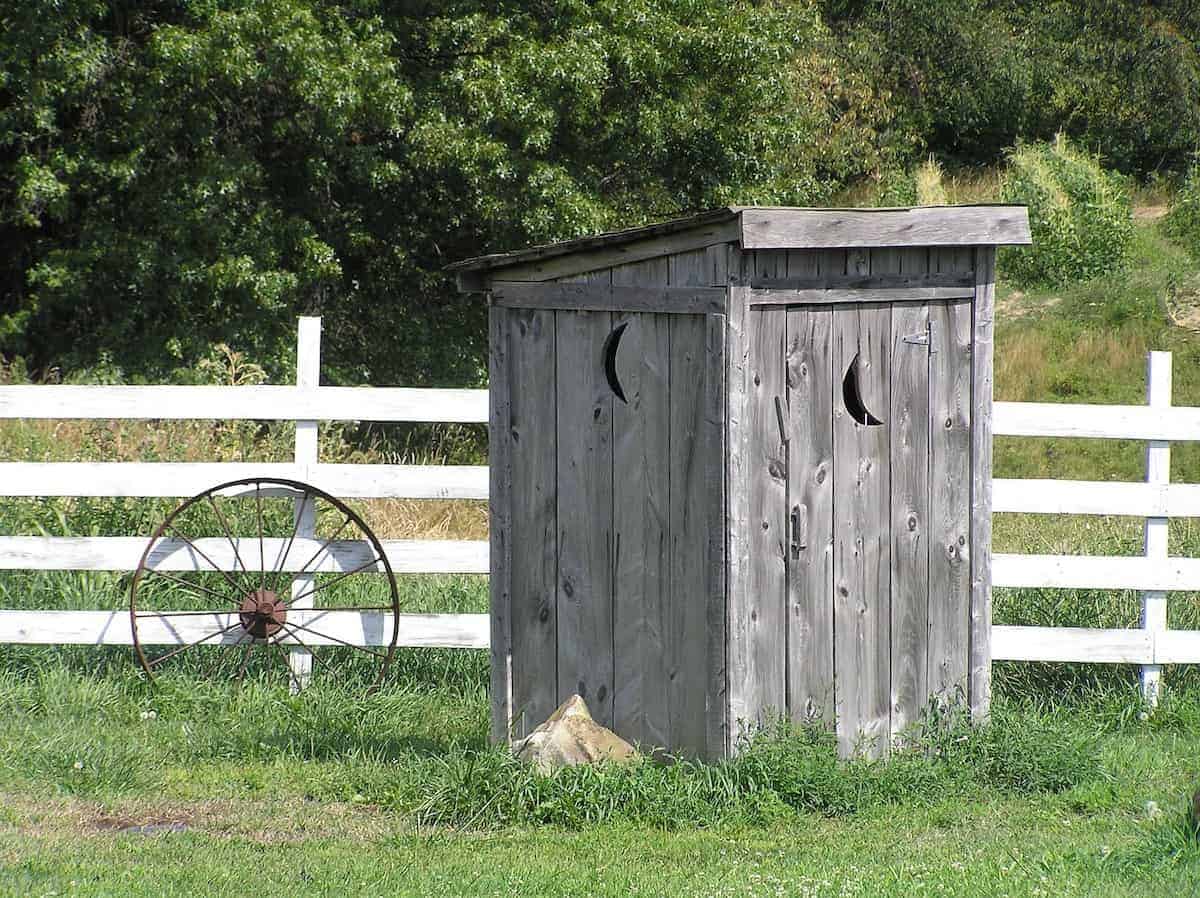 Photo of early septic systems - a rustic outhouse.