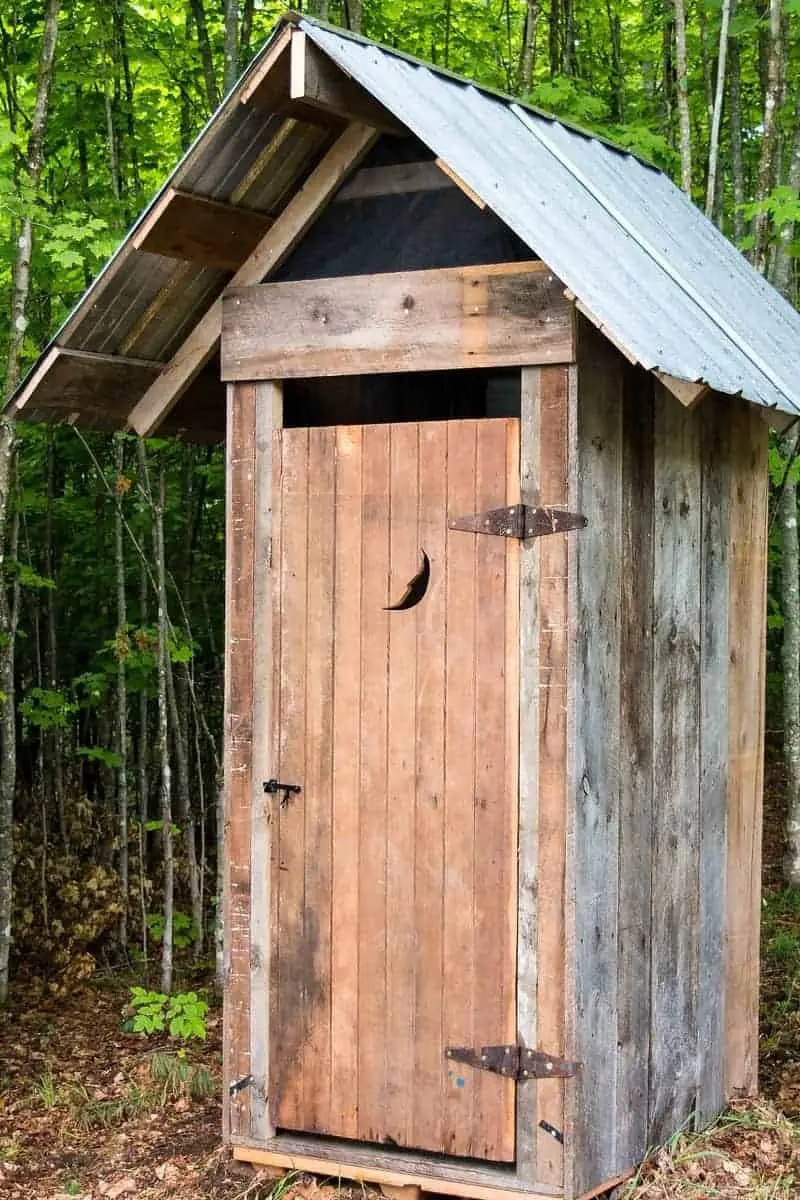 Photo of a rustic outhouse that is a form of septic systems.