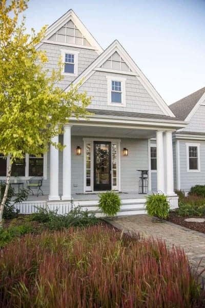 Photo of farmhouse style home with large front porch.