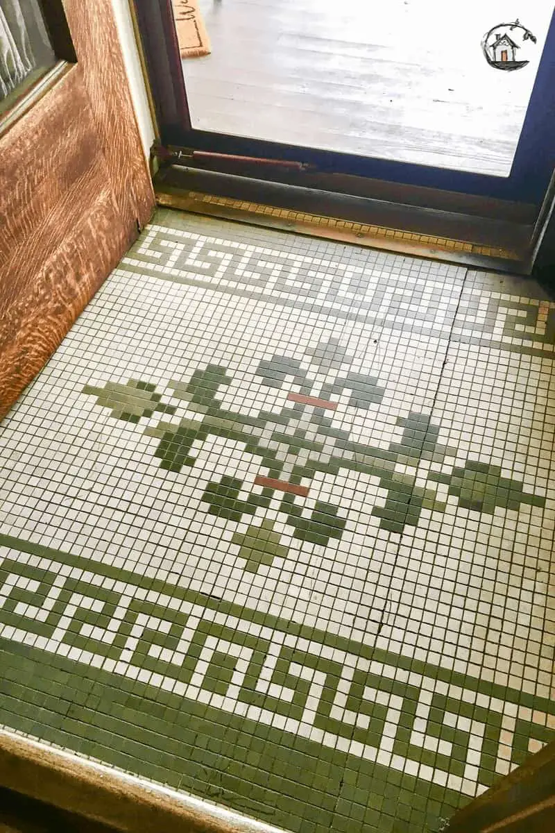 Photo of green and white tile mosaic floor on old house tour. 