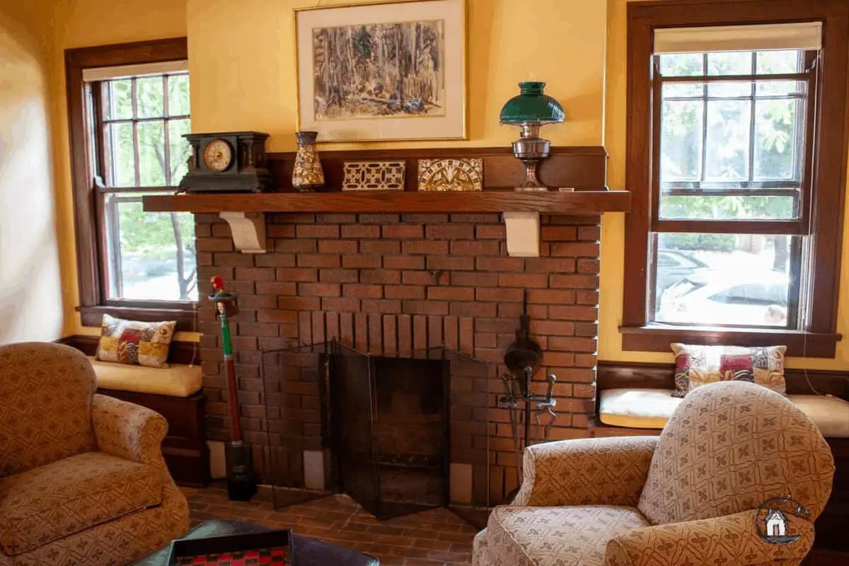 Photo of Arts & Crafts home interior with brick fireplace and windows, as seen on the Old House Society Tour.
