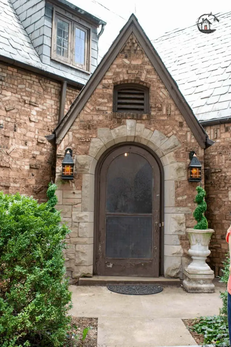 Photo of old house brick entry with Gothic elements.