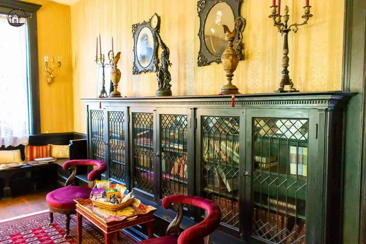 Photo of builtin bookcases with glass front doors in the Vrooman Mansion. 