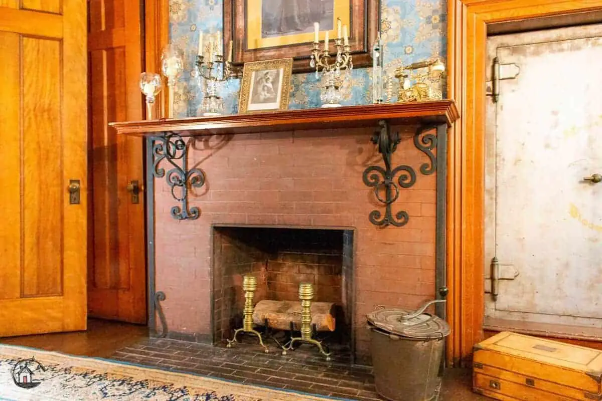 Photo of red brick fireplace in the Vrooman Mansion. 