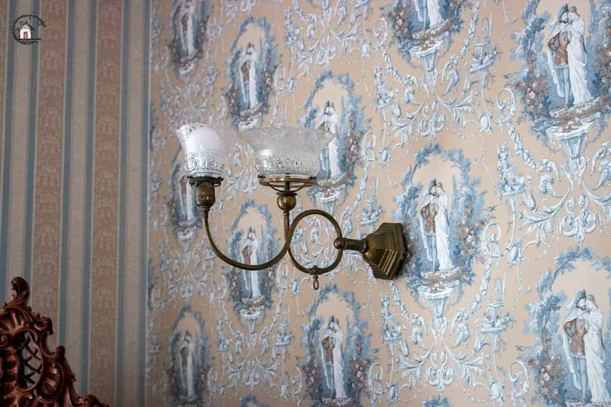 Photo of vintage wallpaper and light fixture in the Vrooman Mansion. 