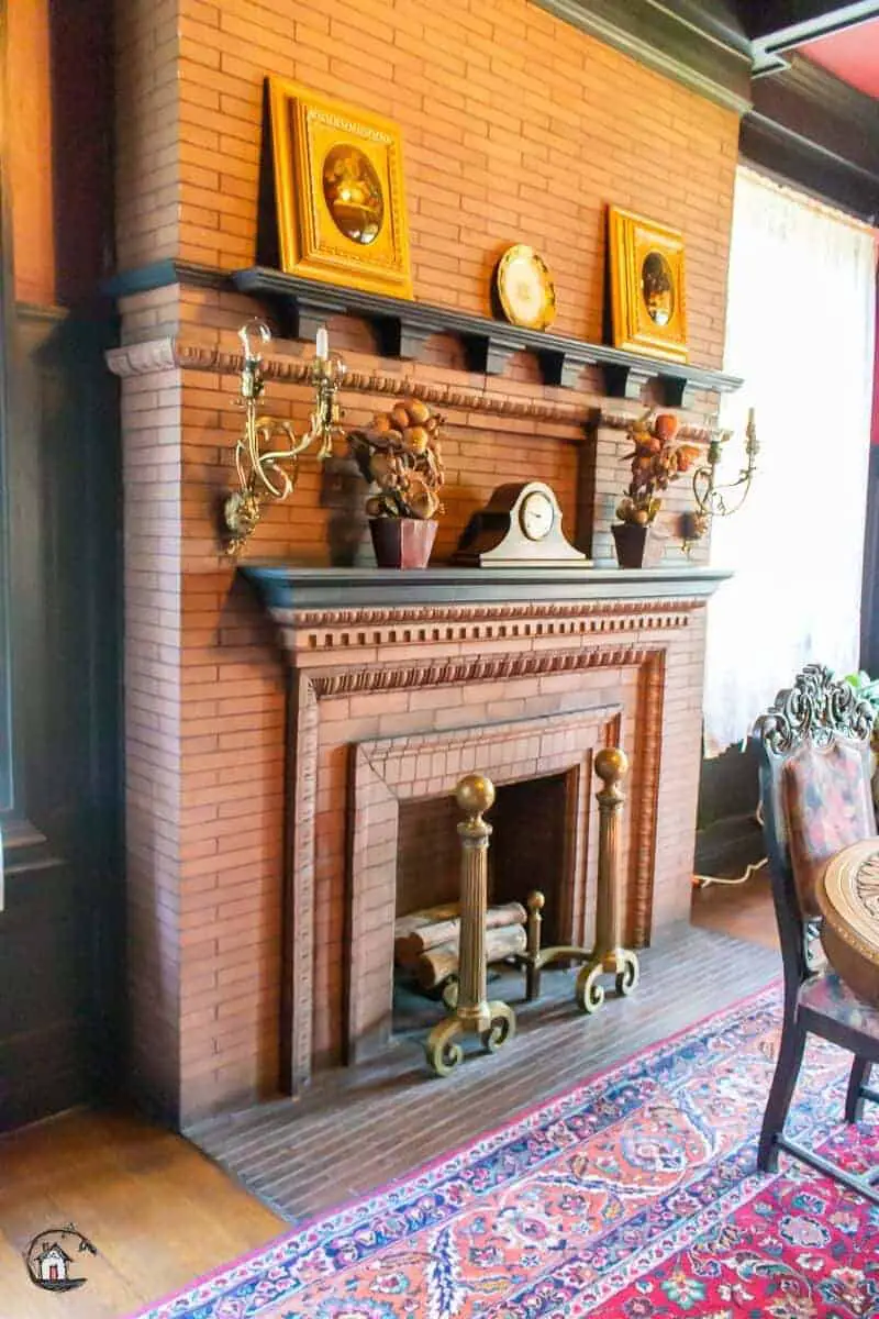 Photo of red brick fireplace in an old house. New houses can learn a lot from old homes. 