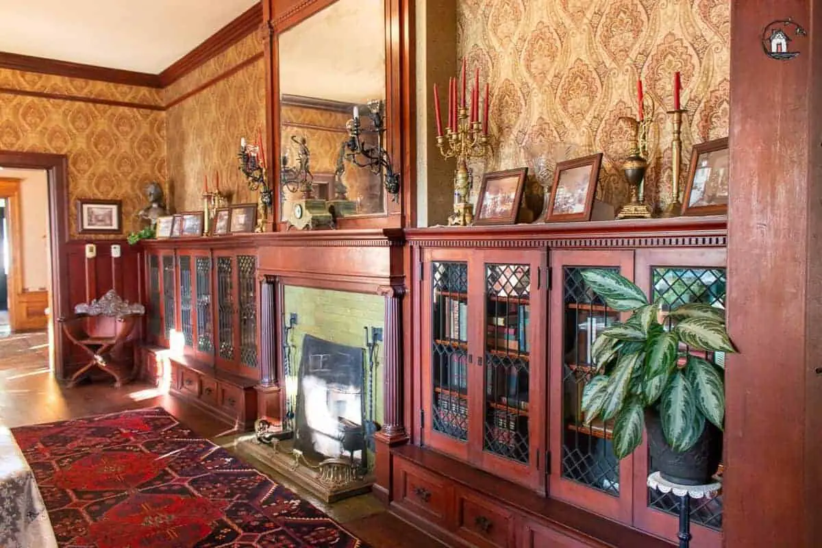 Photo of bookcases with glass doors in the library of the Vrooman Mansion. 