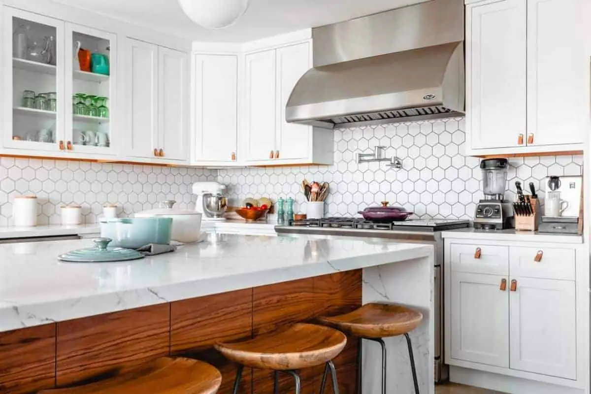 Photo of white kitchen with large island.