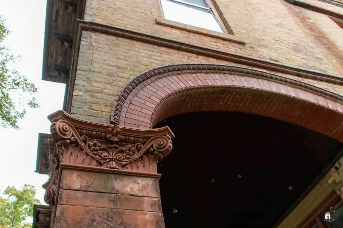 Photo of decorative brick column capital and arched opening on the Vrooman Mansion.