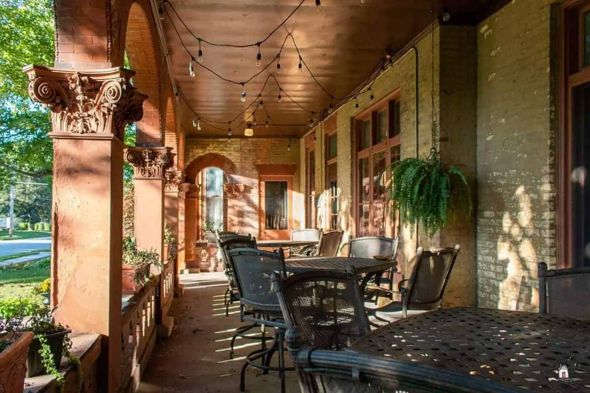 Photo of the porch of an old house with red brick columns. New houses can learn many lessons from older homes. 