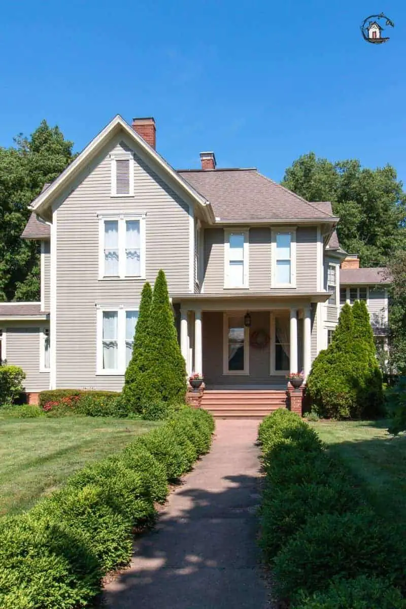 Photo of old house with tan siding. New houses can learn a lot from old houses. 