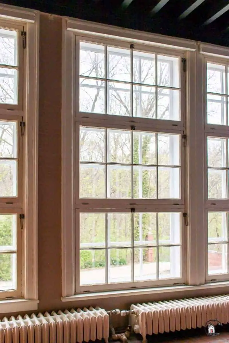 Photo of large windows in an old home. New houses should look to old houses for design inspiration. 