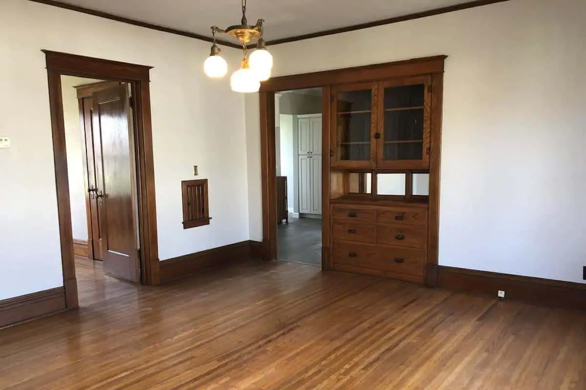 Photo of interior of an American Foursquare home with an oak built in china cabinet. 