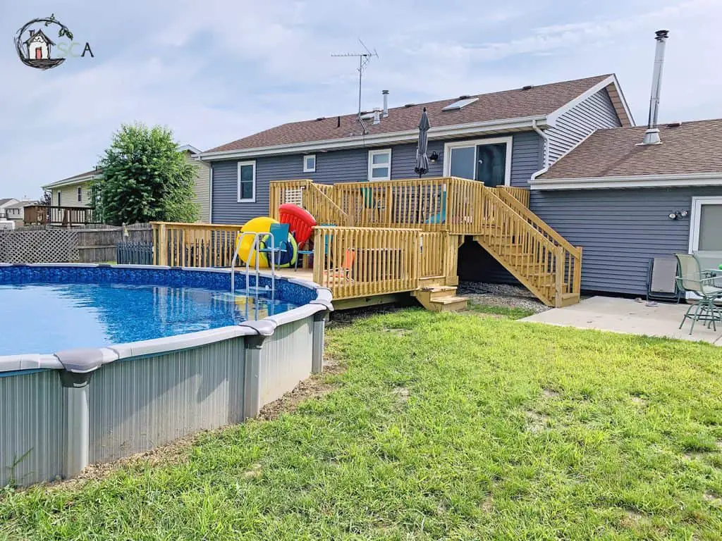 pool and deck with a grey house